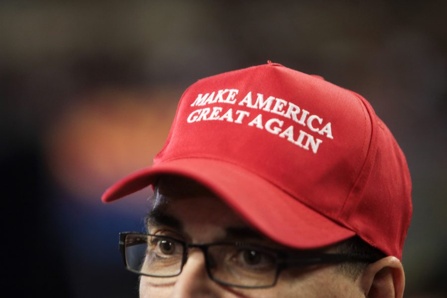 A man wears the signature Make America Great Again hat in support of Donald Trump at a rally at Veterans Memorial Coliseum at the Arizona State Fairgrounds in Phoenix, Arizona. Many voters made their choice with this promise in mind, whatever it meant to them.