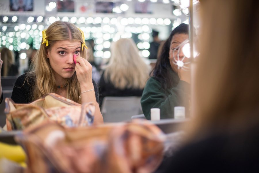 Annie Sherman, Dance major, applies her makeup as she waits for the rehearsal to begin on Thursday, Feb. 24, 2017.