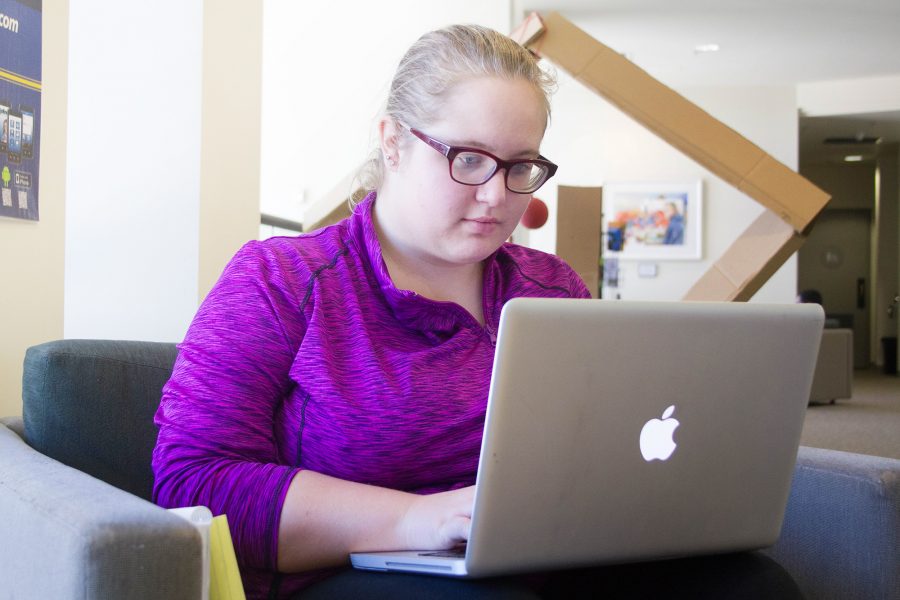 Kayla Randall, biochemistry major, types on a laptop in Moorpark College's Library. Randall relies on scholarships to get through college. Photo credit: Raelyn Rooney