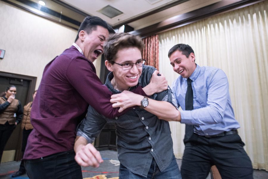 Eric Caldwell (left) and Nathan Espinosa (right) embrace Martín Bilbao, Managing and News Editor, (center) after winning first place for his editorial cartoon, Saturday, April 1, 2017, in Sacramento, Calif. Caldwell is the opinion editor and Espinosa is the Editor-in-Chief for the Student Voice. Photo credit: James Schaap