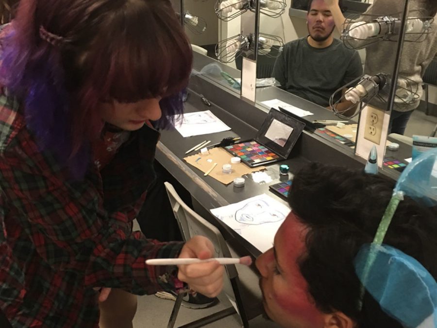 Technical theater major Hayley Westenskow, 19,  puts her makeup skills to the test as she applies the guppalicious makeup to 21-year-old Business and Theater major Christian Sarabia. Photo credit: Lisa Lyons