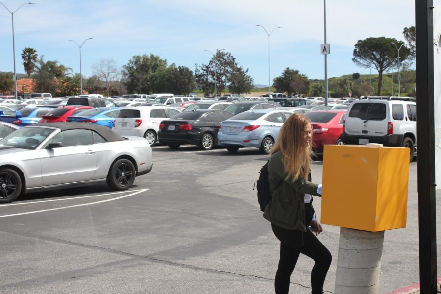 20 year-old psychology major Jessica Powell  buys a one-day parking pass. According to Senior administrative assistant Elizabeth Salas, there are around 4,200 parking spaces on campus for a student body of over 13,000 enrolled students. Photo credit: Cameron Cardy-Sterling