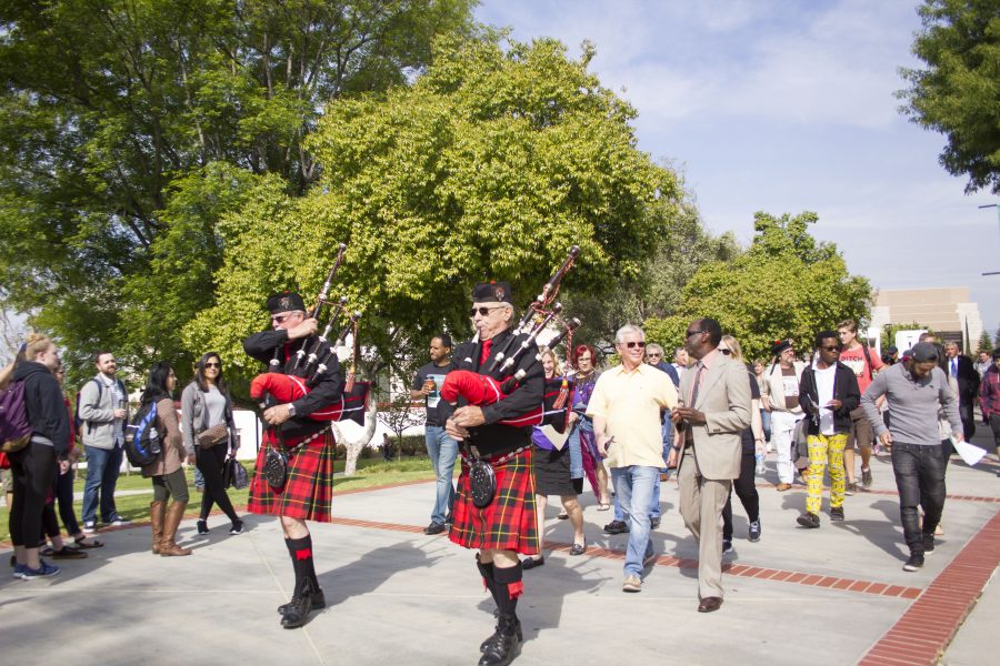Moorpark Colleges Multicultural Day kicked off with a parade led by Scottish bagpipes, followed up by Bernardo Perez, left (in yellow shirt), Board of Trustee member, and Dr. Julius Sokenu (beige suit), Interim Executive Vice President for Moorpark College. April 11, 2017. Photo credit: Karen Alvarez