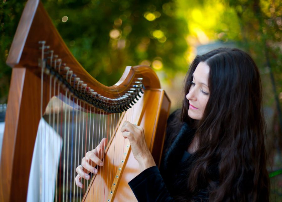 Harpist Hollienea playing the Celtic Harp. Photo credit: Deana Michelle