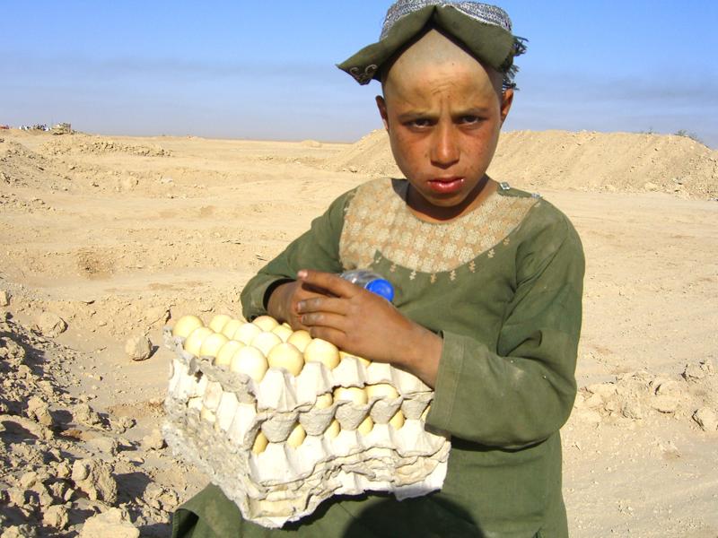 10-year-old native Afghan boy sells eggs for $2 a piece on the street with hopes of supporting his family. Photo credit: Ariana Haider