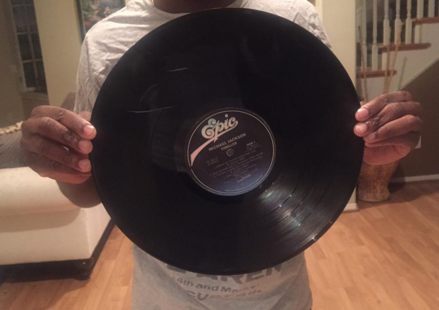 Sam Johnson holds up a vinyl copy of Michael Jackson's Thriller, to represent vinyl's resurgence. Photo credit: Samuel Johnson