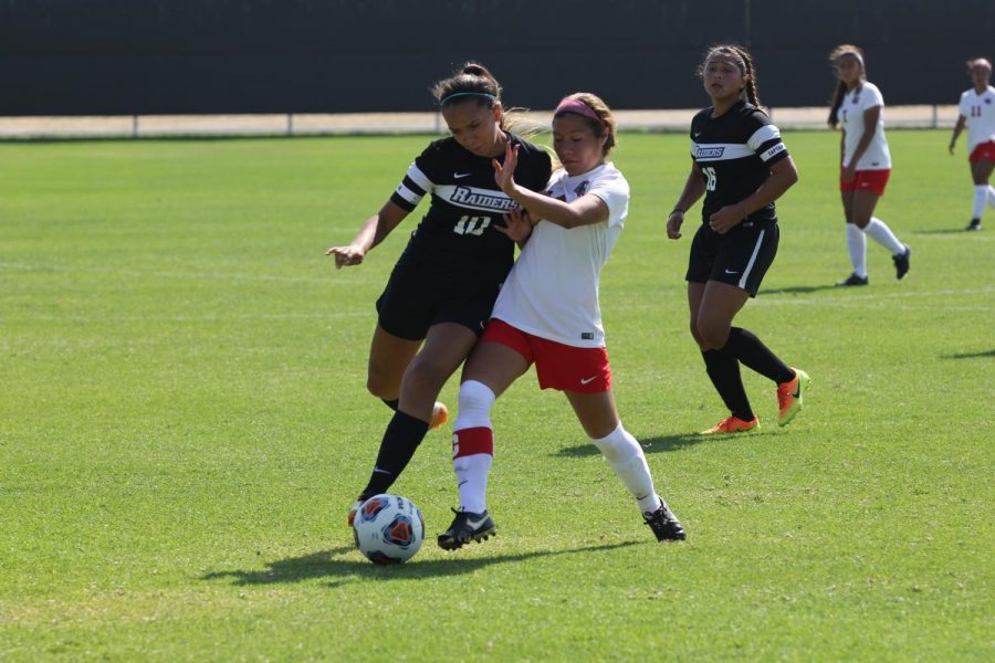 Team captain and midfield player, Danielle Boggess, works hard to step in front of her player and to gain possession of the ball.