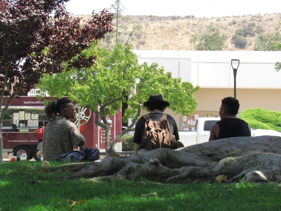 Ash Kennon, 24 (left), enjoys some free time conversing with a couple of fellow students, Kendal Cooper (middle) and Quenton Carson (right), both 18. Breaks could be spent with old friends, or even sometimes making new connections with others. Photo credit: Dallas Vorburger