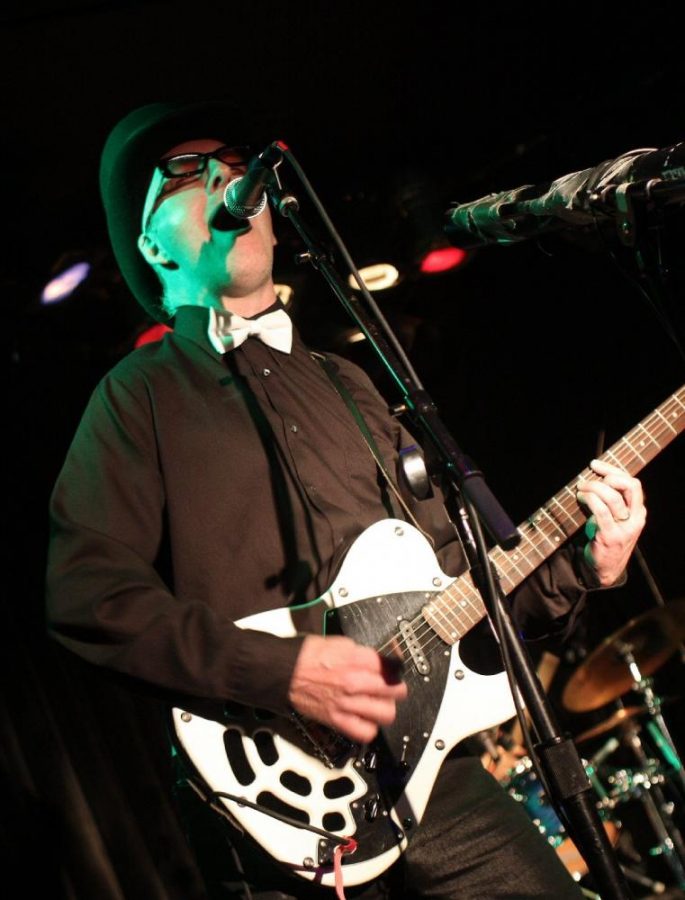 Sugar Panda’s frontman Thaddeus on stage at the Viper Room club in West Hollywood in 2012. He is singing while playing the special baritone electric guitar. Photo credit:  Kaley Nelson