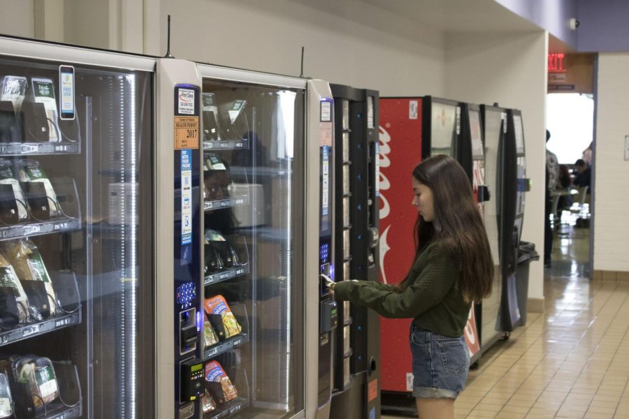 Mandy Deitelbaum, 17, film major, purchases an item from the vending machine. Since 2012, food options at Moorpark College have been limited. Photo credit: Danny Corrigan