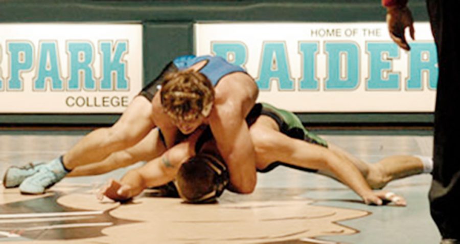 Former student Tod Malesworth pins down a Cuesta College student in 2006. The five time state championship wrestling program, cut in 2009, has now been reinstated on campus. Photo credit: Steven Hunter