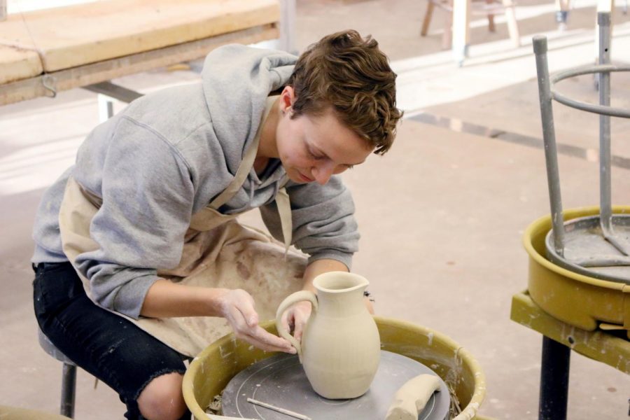Brianna Carlson, 21, Political Science major, molds a piece using a pottery wheel. Photo credit: Cole Carlson