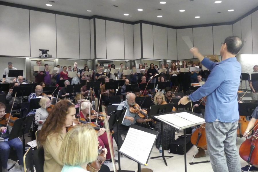 The Moorpark College Symphony Orchestra and Symphonic Chorus are playing instruments and singing in the orchestra room on Nov. 2, 2017. Moorpark College professor and symphony music director James Song conducts while the students rehearse for the upcoming Holiday Lights concert on Sat. Dec. 2, 2017. Photo credit: Ian Cohen
