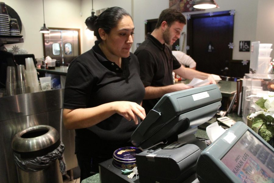 Jinkys Café employees Lauren DeStefano, left, and Matt Rhodes, right, work quickly to put in orders from the Black Friday rush. Many businesses like Jinkys are hiring seasonal employees to compensate for the increase in customer demand. Photo credit: Ash Dondeti