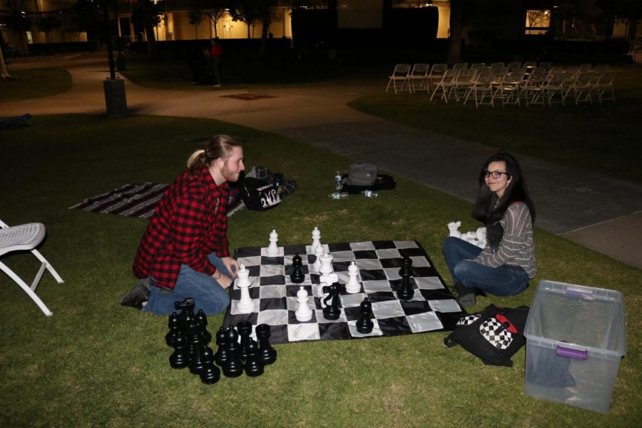 Students play chess on the campus quad before a a screening of La La Land. The Valentines day movie night was organized by Associated Students to build a sense of campus community. Photo credit: Kevin Bell