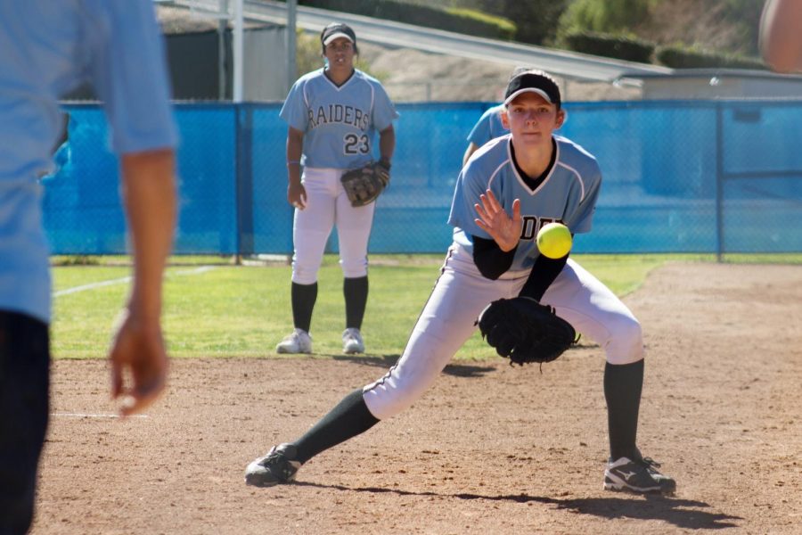 Aubrey Sutherland practices pitching and catching with Assistant Coach Joe Mike (left) while Sierra Huerta watches from behind, on Friday, Feb. 16, 2018 at Moorpark College, in Moorpark, Calif. The team was warming up for the first of two games against the West LA College Oilers. Photo credit: James Detwiler