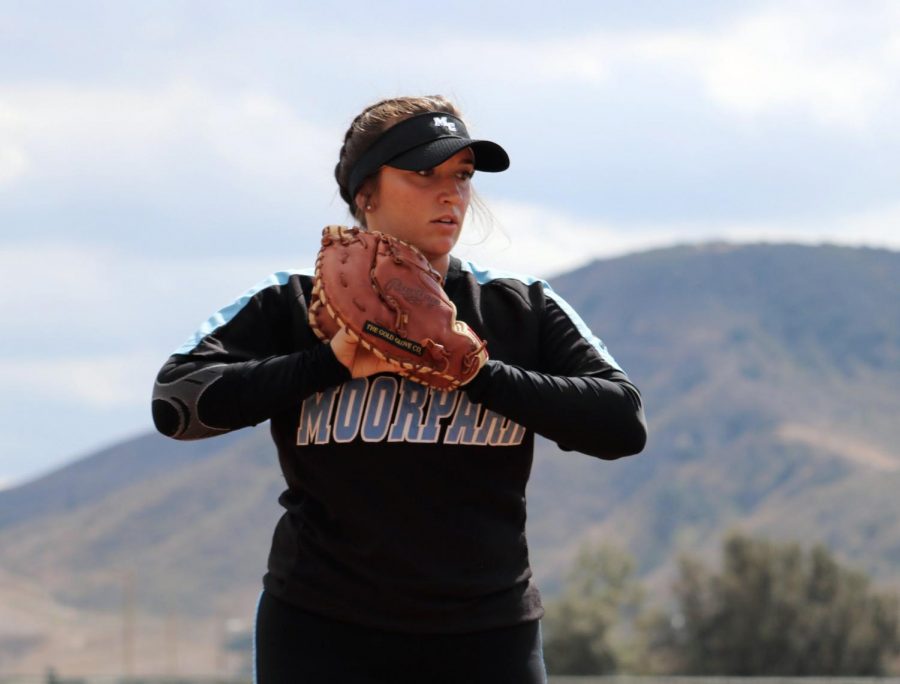 Raiders pitcher, Phoebe Jackels, practicing her throwing motion during pre-game drills. Photo credit: Ryan Ketcham