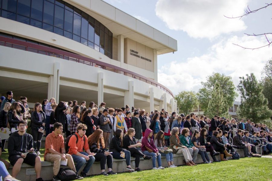 Hundreds of Moorpark College students stand on the steps outside the library building. Students and faculty walked out of their 10 a.m. classes to stand against gun violence. Photo credit: Martin Bilbao