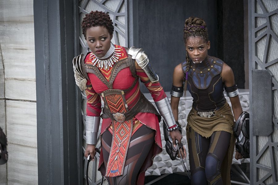 Left%2C+Nakia+%28Lupita+Nyongo%29+and+right%2C+Shuri+%28Letitia+Wright%29+creep+up+to+fight%2C+armed+with+their+vibranium+weapons+that+were+created+by+Shuri.+They+are+both+dressed+in+the+modern-African+inspired+costumes+that+were+part+of+Ruth+Carters+vision+for+the+film.+Photo+credit%3A+Disney%2FMarvel+Studios