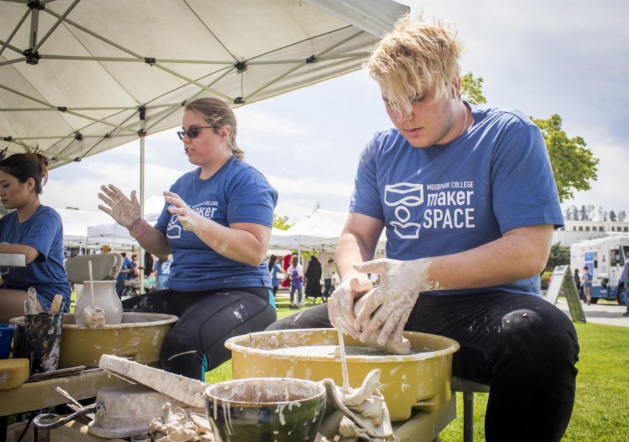 Clarissa Trapp (left), 28, and Nicholas Rood, 19, mold some wet clay on their pottery wheels, during the Maker Faire at Moorpark College, on April 24, 2018. Trapp voiced her passion for the class, although being a nutrition major. Photo credit: Evan Reinhardt