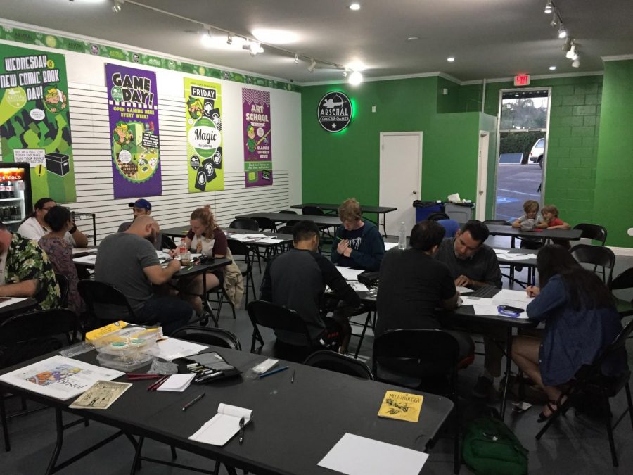 Members of the Arsenal Art Collective work on their illustrations at Arsenal Comics and Games in Ventura on Oct. 21. Photo credit: Oliver Manzano