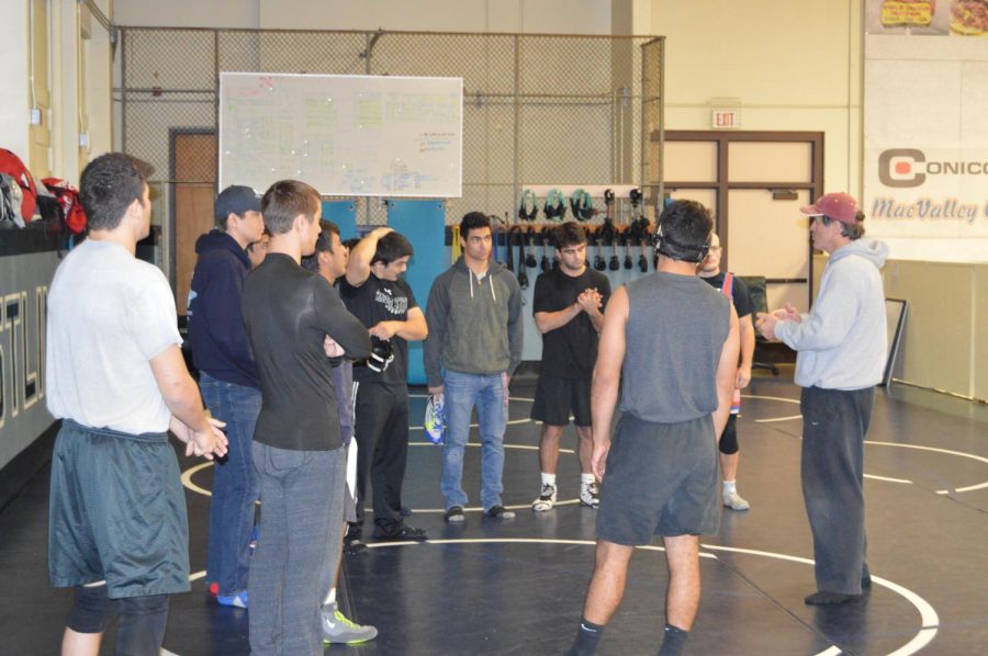 Coach Lindley Kistler talking to the wrestlers before practice for the State Championships. Photo credit: Alex Behunin
