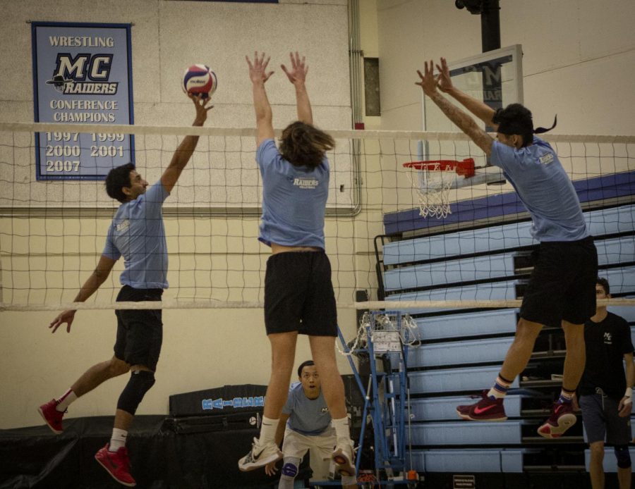 Opposite Hitter Jay Ahir, left, attempts to tip the ball over fellow teammates Collin Weaver, middle, and Brandon Dela Fuente during practice in the Moorpark College gym. Photo credit: Evan Reinhardt