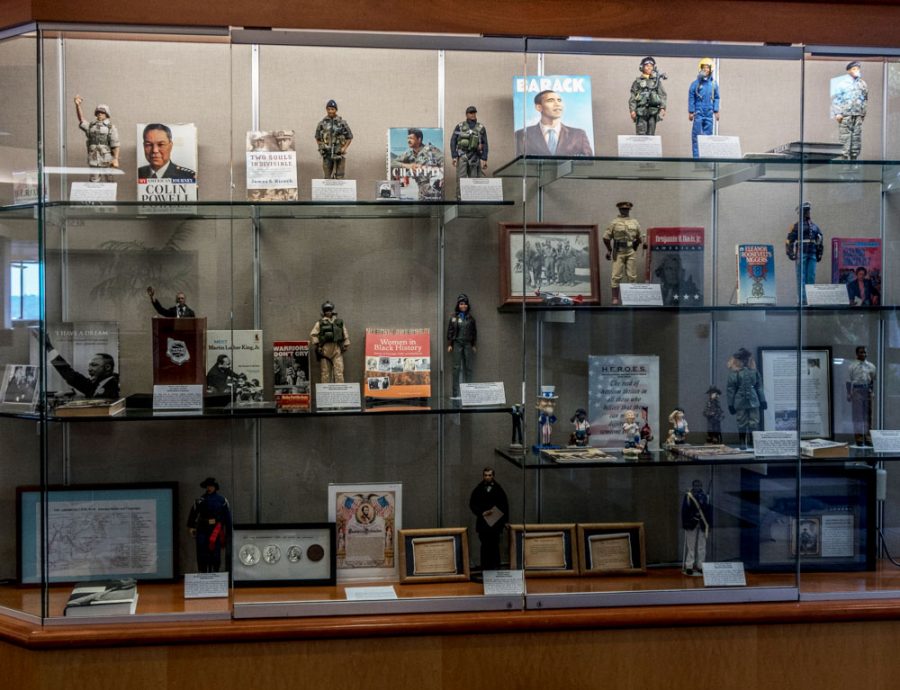 All of the figurines, books, photos and coins are located in the glass display in the library at Moorpark College are displayed to honor Military and Armed Forces. They are being displayed by H.E.R.O.E.S. on Wednesday, Feb. 20. Photo credit: Megan Pearson