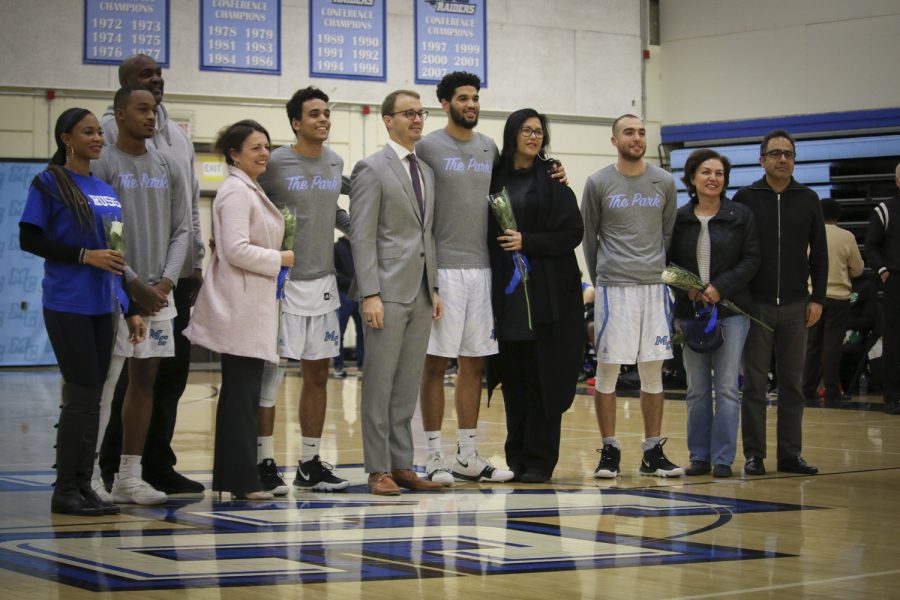 Graduating sophomores stand with parents and Head Coach Gerred Link, center, in honor of their last home basketball game of the season on Tuesday, Feb. 19, in the Moorpark College gym. In celebration, each sophomore started in the game against Oxnard College. Photo credit: Evan Reinhardt