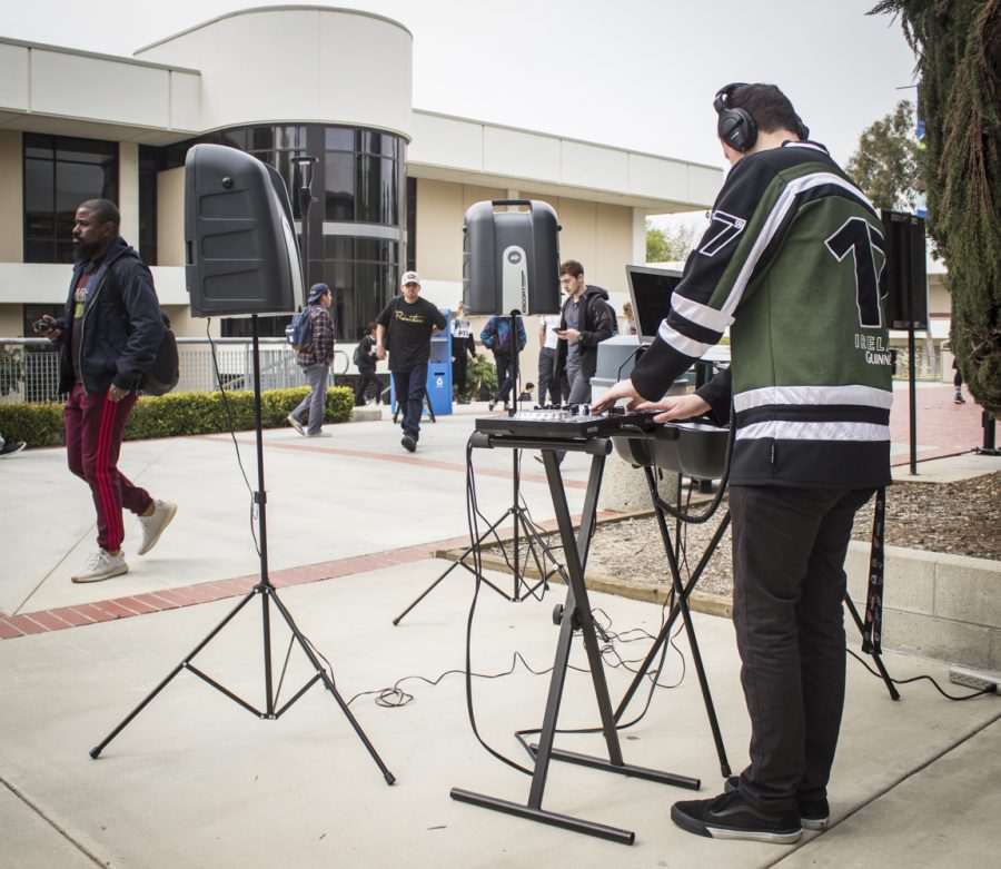 Andy Soto, 18, mixes music outside Fountain Hall during a DJ set on Tuesday, Feb. 26. Soto is in the music program at Moorpark College, and claims he started mixing music in middle school. Photo credit: Evan Reinhardt