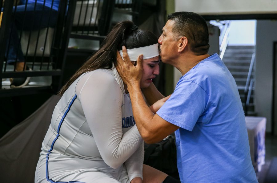 Moorpark Colleges Barbara Rangel is consoled by her father, Juan Rangel after leaving the game with a knee injury that occurred in the third quarter of the CCCAA state championship game against Diablo Valley College, played at Ventura College on Sunday, March 17, 2019.  Moorpark lost to Diablo Valley, 68-61. Photo credit: Jace Kessler