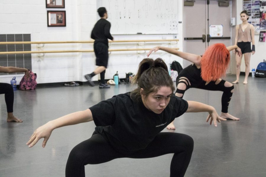 Malia Rogers, 20, strikes a low pose during the dance rehearsal for the modern dance class piece titled Voo-Doo. Photo credit: Margot Rowe