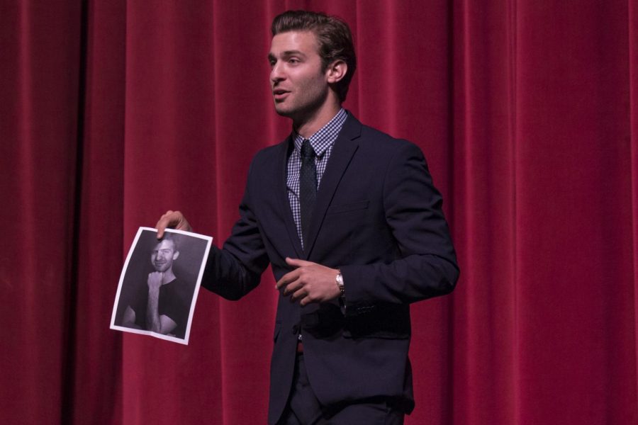 Nathan+Shapiro+pulls+out+his+own+headshot+while+giving+a+humorous+speech+about+toxic+masculinity.+Shapiro+and+his+fellow+forensic+debate+team+members+performed+their+speeches+Tuesday%2C+April+2+at+the+Moorpark+College+Performing+Arts+Center+before+heading+to+nationals.+Photo+credit%3A+Isabel+Simpson