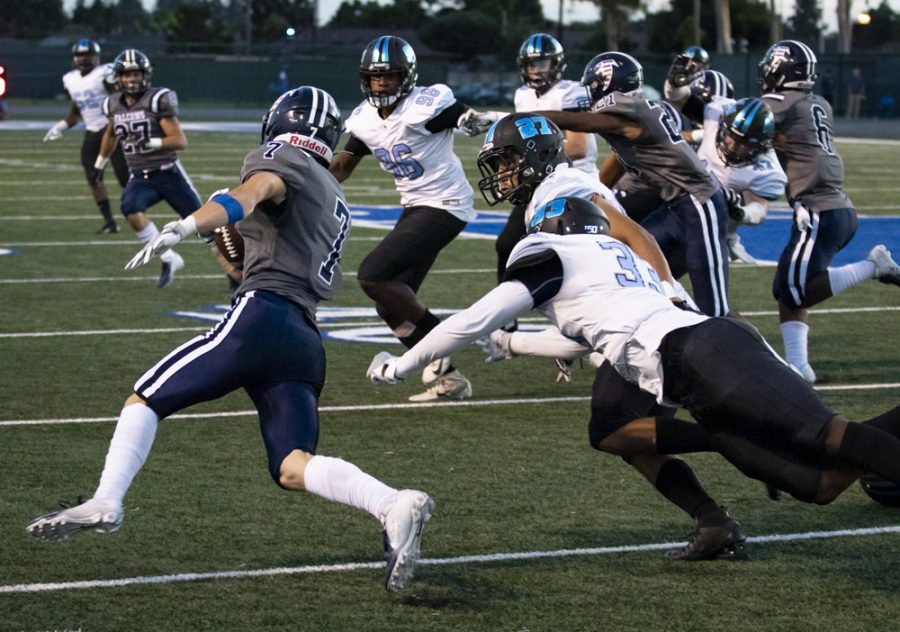 Falcon Wide Receiver Jovohn Tucker, 7, escapes Raider defenders during Moorparks game against Cerritos College in Cerritos, Calif. on Saturday, Sept. 14. Moorpark struggled on defense, missing several tackles and executing no sacks. Photo credit: Evan Reinhardt