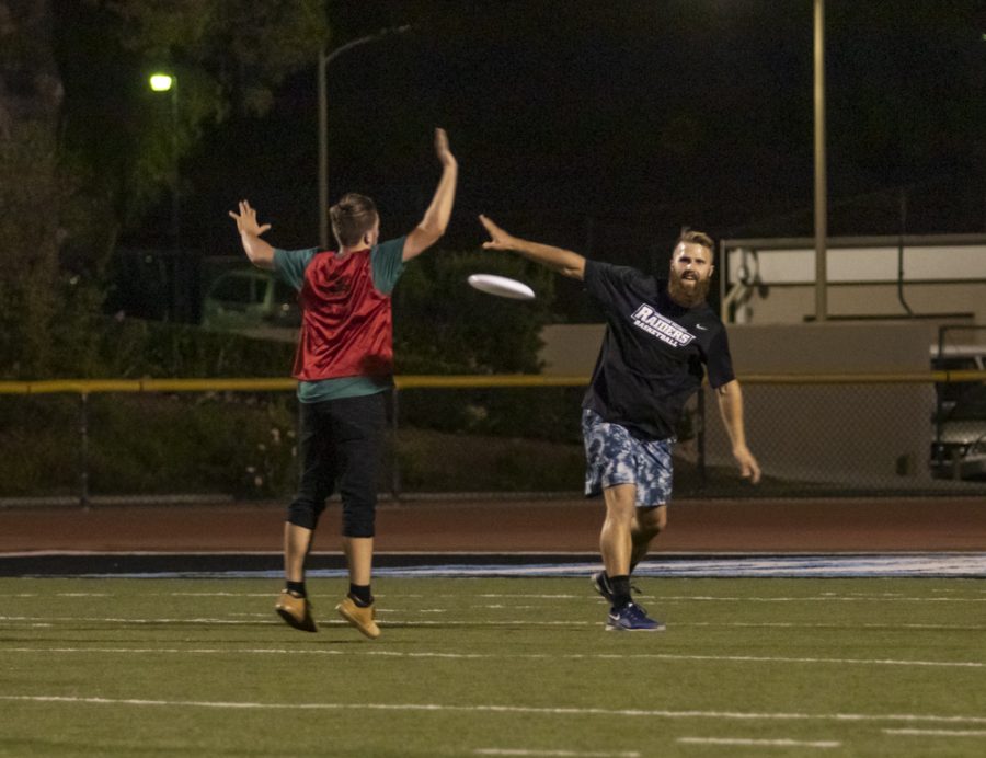 Kyle Innocenti attempts to block a pass from Brock Cushings, Moorpark faculty member, during the game of ultimate frisbee on Thursday, Oct. 3. The FLeX program hosted the game at Griffin Stadium. Photo credit: Evan Reinhardt