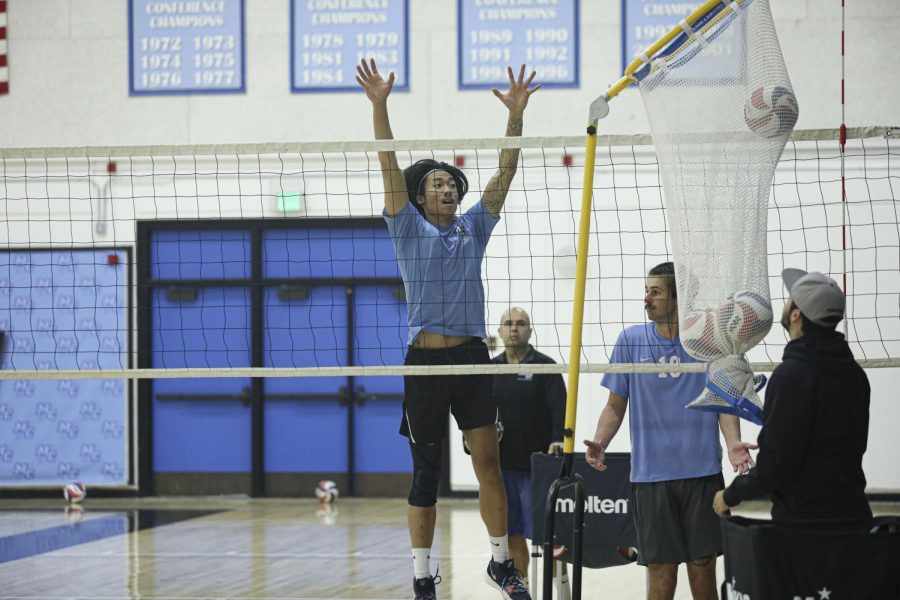 Brandon Dela Fuente, a middle for the Moorpark mens volleyball team, practices a blocking drill with his teammates on Tuesday, Jan. 21. at Moorpark College. Photo credit: Ryan Bough