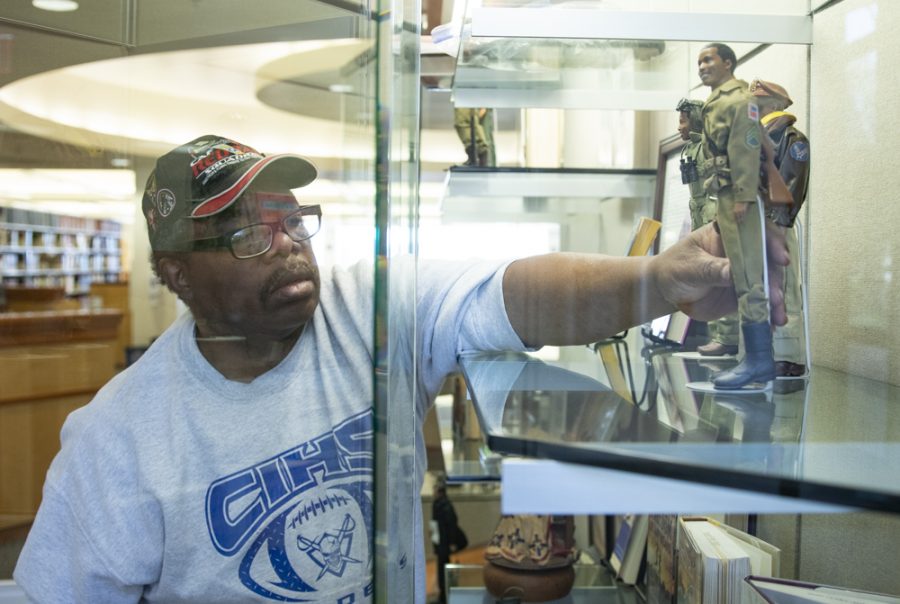 Lawrence Lee, military enthusiast, sets up the display in the library on Friday, Feb. 7. Lees display showcases the many aspects African American history, including military service. Photo credit: Evan Reinhardt