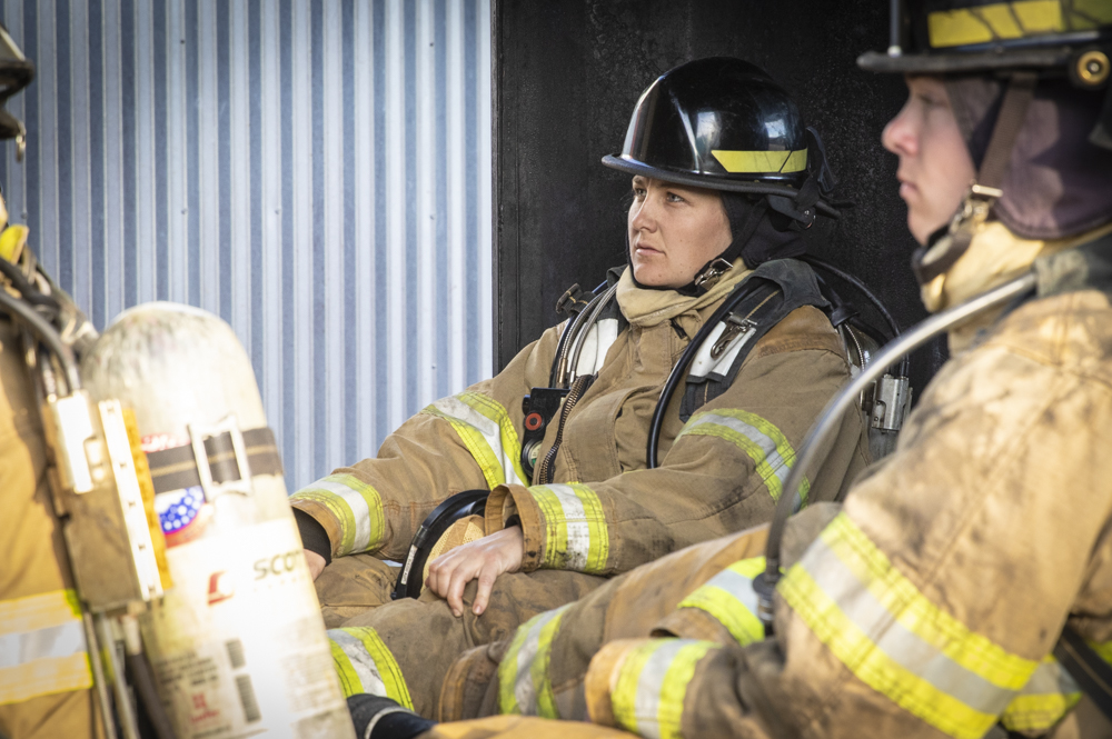 Cadet Melissa Corney watches the instructor prior to a live fire training exercise on the Oxnard College Fire technology training grounds in Camarillo, Calif. on Wednesday, Feb. 26. Corney is a student in the Fire Technology program.