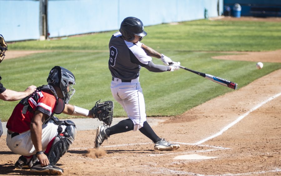Sophomore Leighton DeMello makes contact with a pitch during the Raiders home game against Pierce College on Saturday, Feb. 29. DeMello ended the game with one run from three at-bats. Photo credit: Evan Reinhardt