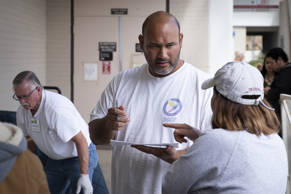 Alejandro Castro, the food pantry manager, assists attendees on Tuesday, March 17, at Moorpark College. Due to high demand, the pantry was forced to hand out prepackaged amounts of food in order to deter stockpiling.