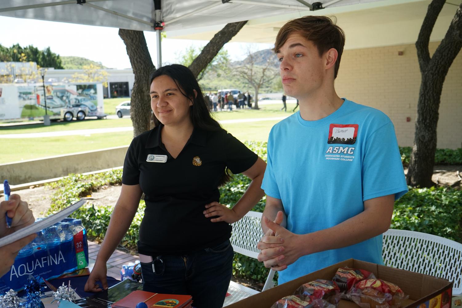 Career Transfer Center worker Jessica Forter, 24, and Communications club president Barrett Kocher, 20, help out with the process of finding internships and jobs during the Career and Internship Expo