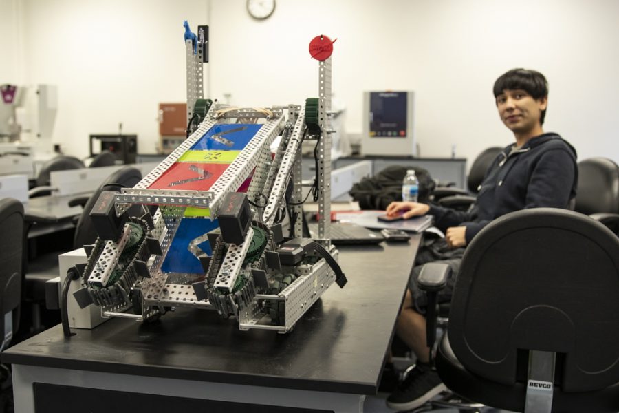 Bobby Lara, president of the Engineering Club, sits beside the robot built by the club, on Tuesday, Feb. 11, in PS 208. The Club has brought their creation to contests, competing against other engineering programs, such as University of Southern California. Photo credit: Evan Reinhardt