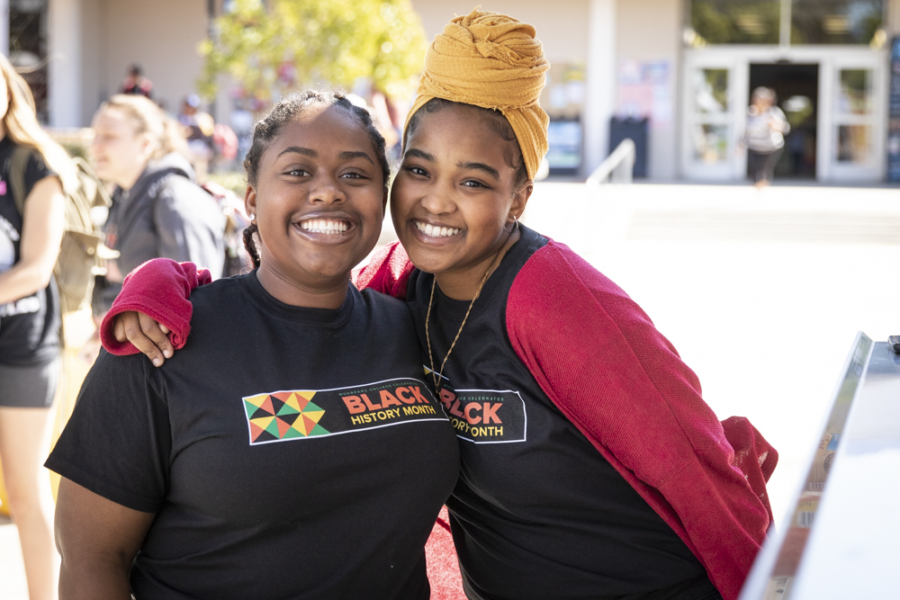 Madison Hunter, left, and Ge Abdalla pose for a picture while waiting for their barbecue food during the Black Family Reunion on campus on Tuesday, Feb. 24. Both are officers for the Black Student Union on campus; Hunter is the secretary and Abdalla is the president.