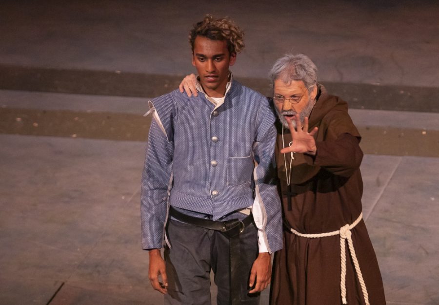 Seth Gunawardena, as Romeo, listens to advice from Pi McAuliffe, as Friar Lawrence during the performance of Romeo and Juliet on Tuesday, March 12, in the performing arts building. Photo credit: Evan Reinhardt