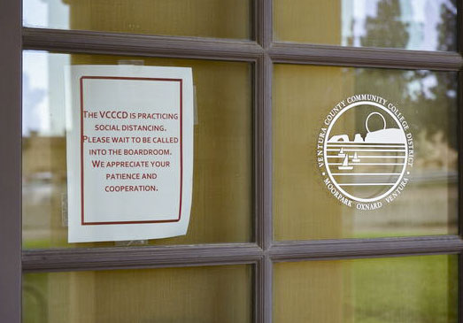 Flyers posted outside the VCCCD Board meeting room asking the public to wait to be called in an effort to practice social distancing at the special board meeting on Tuesday, March 18, in Camarillo, Calif. Photo credit: Gavin Woods