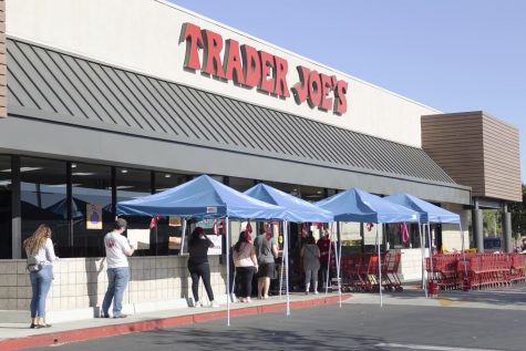 Customers keep their distance while waiting to enter Trader Joe's during the COVID-19 pandemic on Wednesday, May 13, in Simi Valley, Calif.