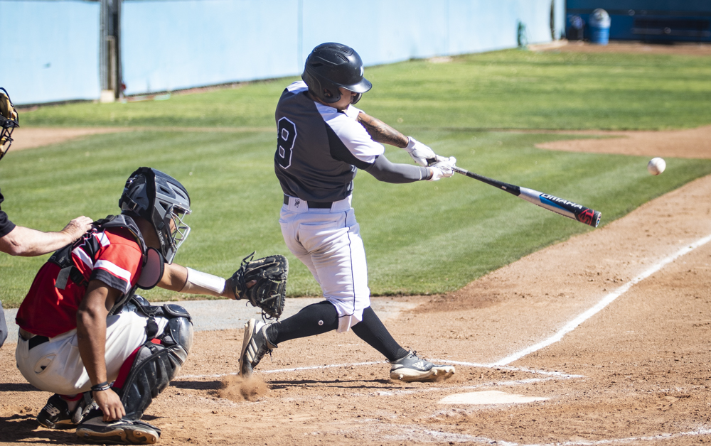 Sophomore Leighton DeMello makes contact with a pitch during the Raiders' home game against Pierce College on Saturday, Feb. 29, 2020. DeMello ended the game with one run from three at-bats.