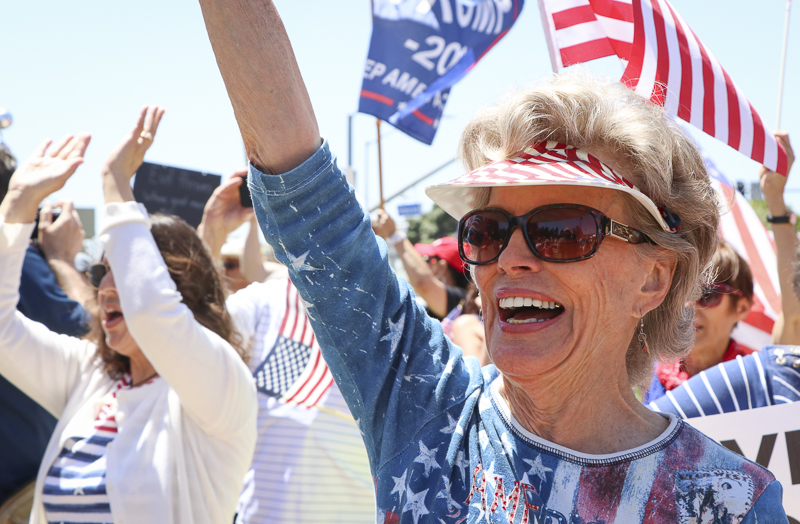 Dea Coletti shows her support for the reopening of California at a protest held at the Ventura County Government Center on Friday, May 1, in Ventura, Calif. Community members gathered in patriotic clothing with signs and flags to help convey their message. Photo credit: Morgan Ellis