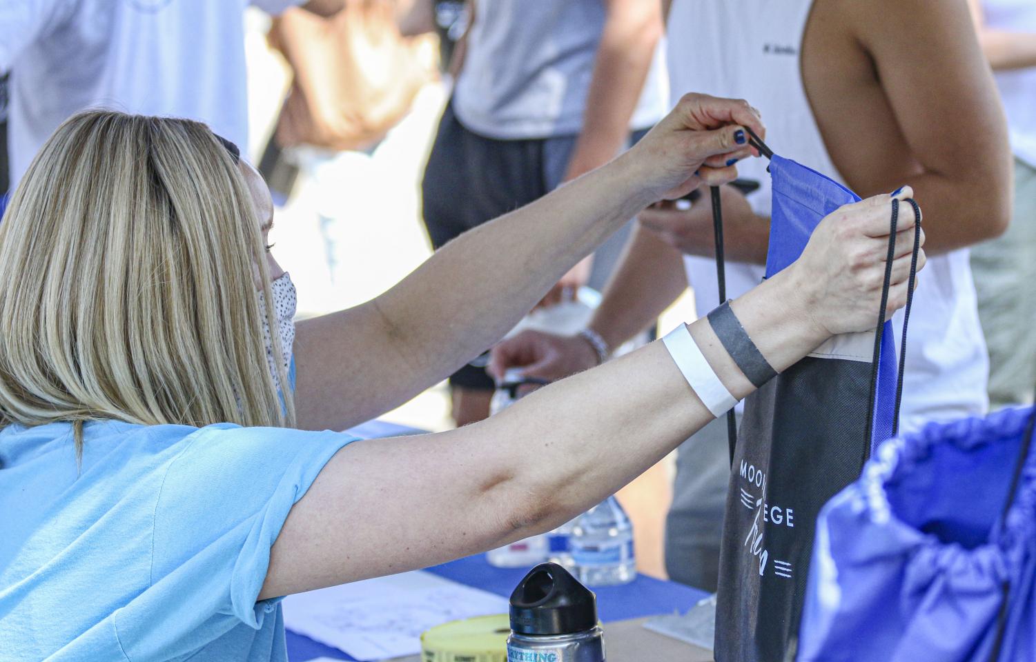 Moorpark College's Student Activities Specialist Kristen Robinson passes out Moorpark College merchandise bags at New Student Welcome Day on Monday, Aug 9, 2021.