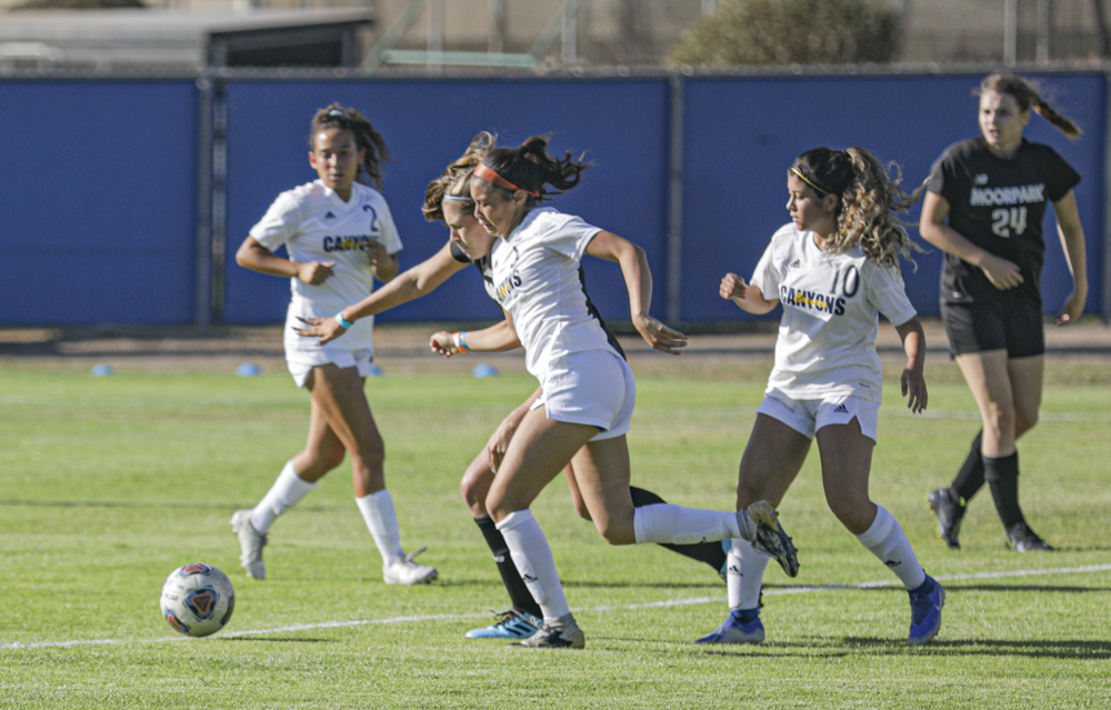 Moorpark and College of the Canyons players fight for the ball during the Women's Soccer game on Tuesday, Sept. 14, in Moorpark, CA.
